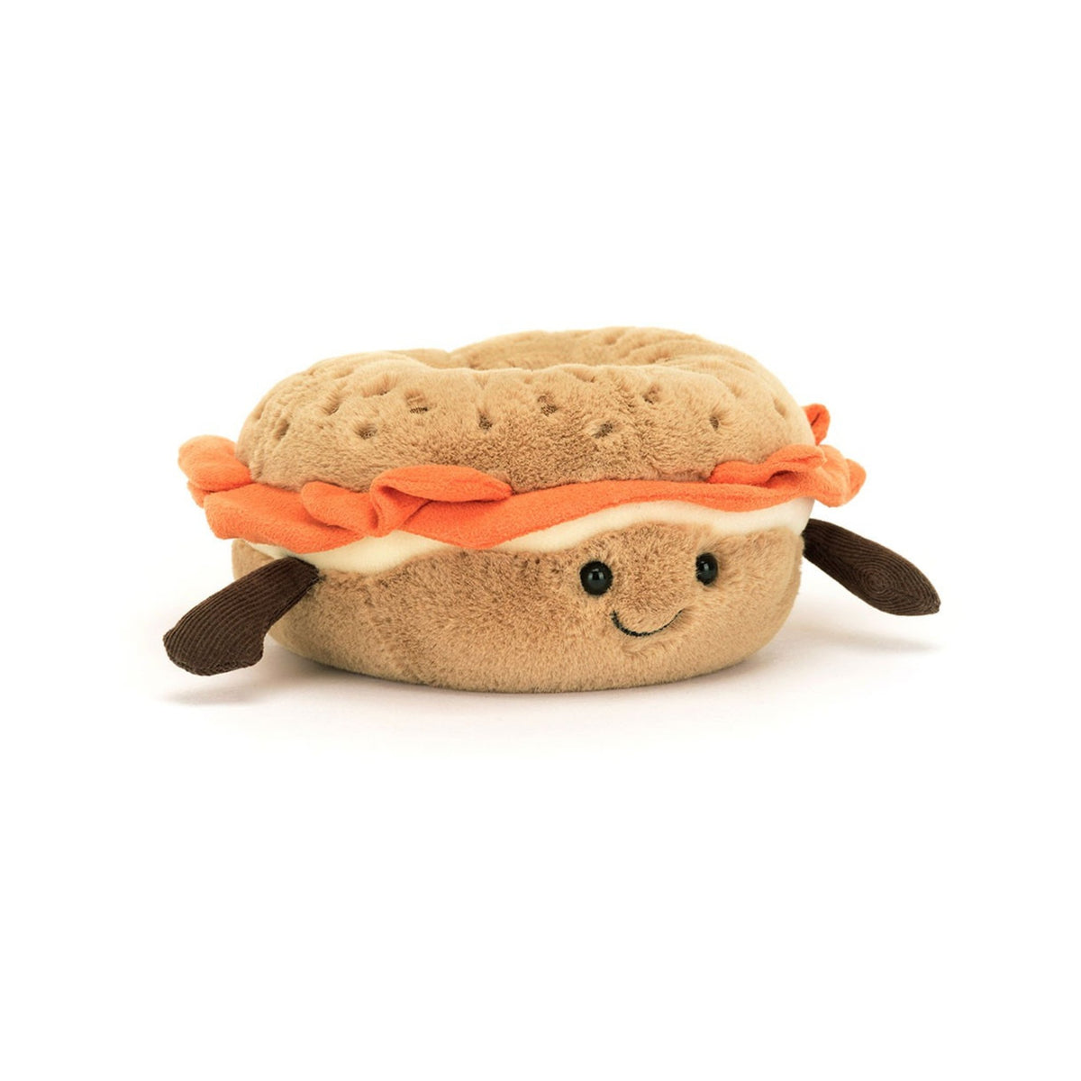 A soft plush bagel toy featuring a golden brown crust with stitched sesame seeds, layered with faux suedette cream cheese and salmon, and tiny brown corduroy legs.
