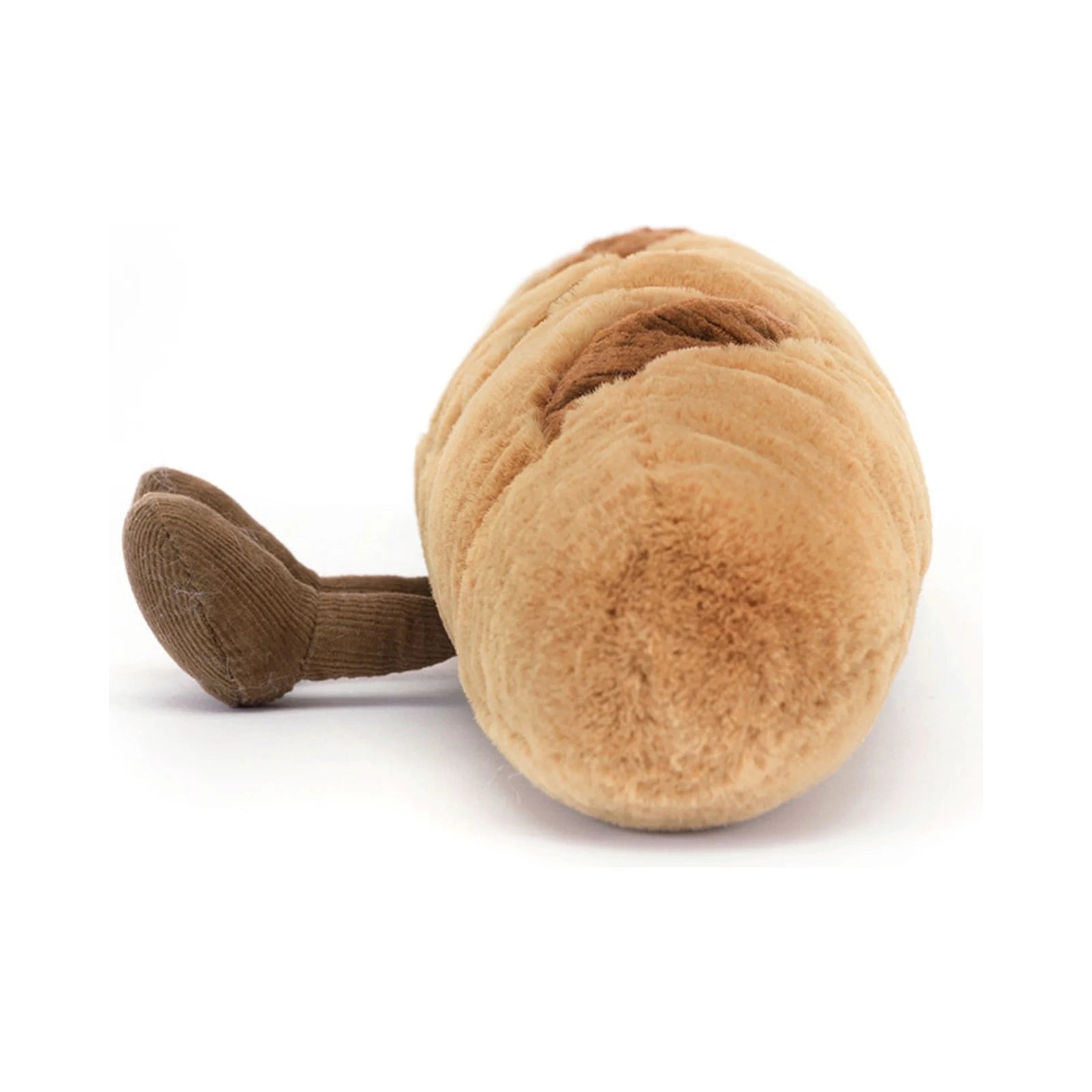 Jellycat Amuseables Baguette plush toy shown from a side angle, featuring a soft golden brown textured body with dark brown score marks and little brown corduroy legs.