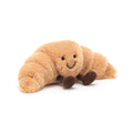 22cm Jellycat Amuseables Croissant soft toy featuring golden-brown crescent-shaped plush pastry, a sweet smiling face, and brown cordy legs.