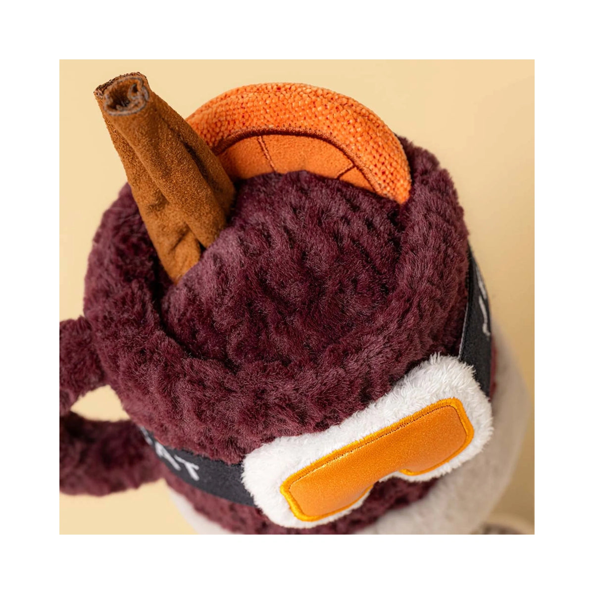 Top view of Jellycat Amuseables Mullover Spiced Drink showing orange padded ski goggles.