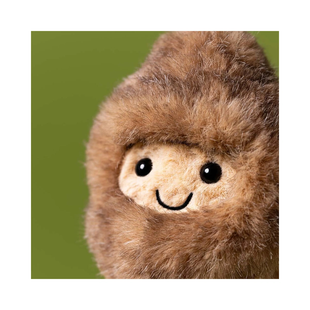 Close up detail of Jellycat Amuseables Peanut Yeti Outfit showing fluffy brown faux fur hood and smiling embroidered face.