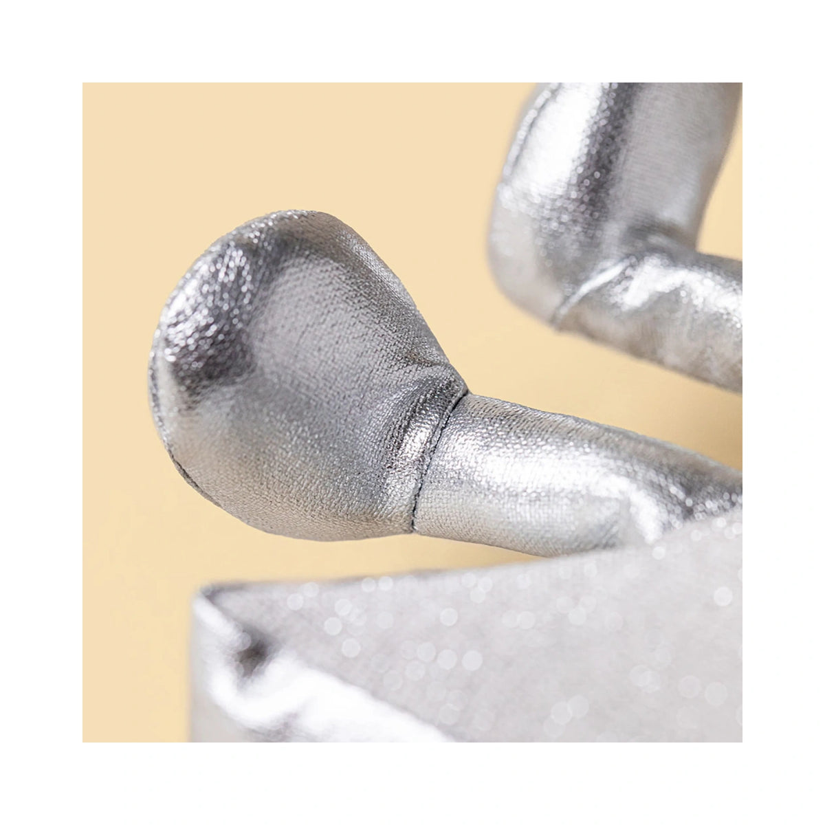 Close up detail of Jellycat Amuseables Silver Star showing shimmering silver plush leg detail.