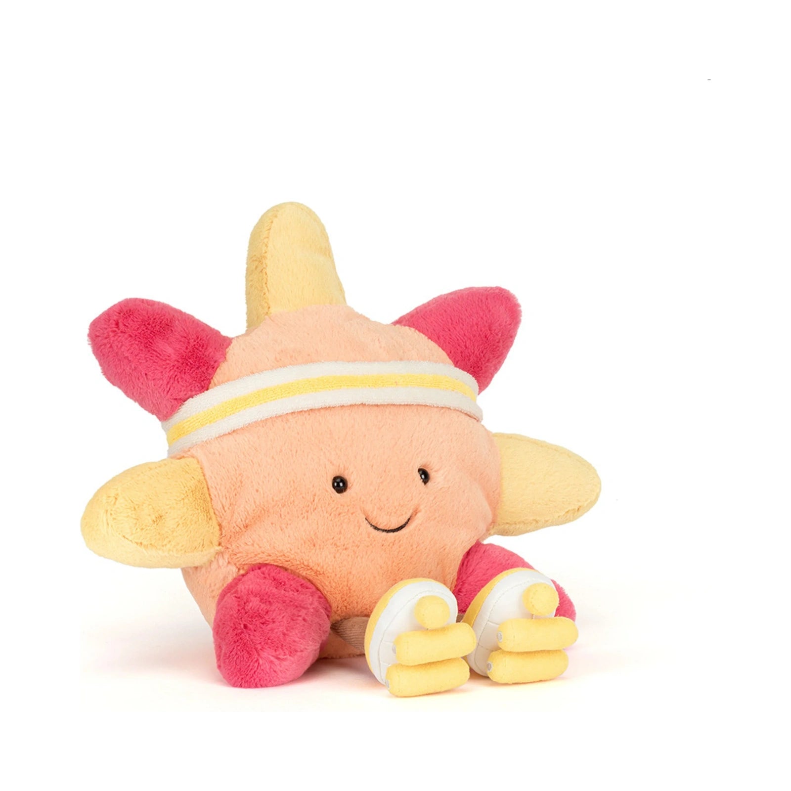 The Jellycat Amuseables Sun Roller Skates plush toy features a smiling peach colored sun character wearing a yellow and white striped sweatband, hot pink rays, and yellow roller skates.