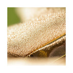 A close up detail of the Jellycat Amuseables Zapperty Lightning Bolt showcasing the sparkling gold metallic knit texture and shiny gold faux leather trim.