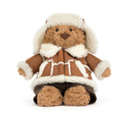 Front view of Jellycat Bartholomew Bear Alpine showing knitted brown plush trousers.