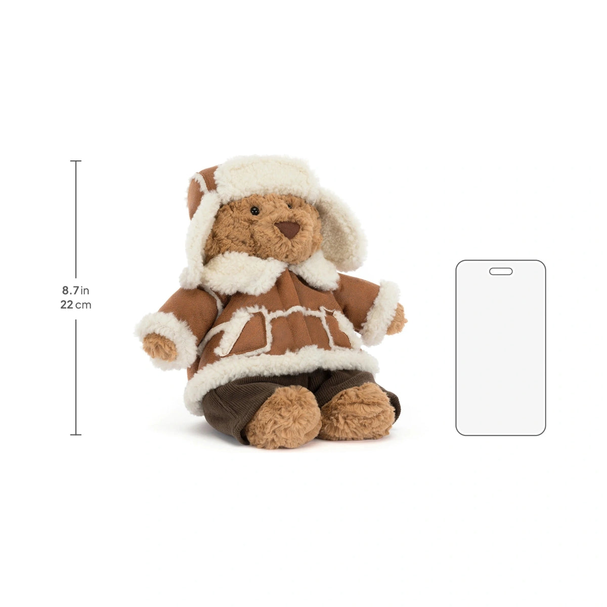 Scale reference of Jellycat Bartholomew Bear Alpine next to fluffy alpine winter coat.