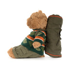 Side view of Jellycat Bartholomew Bear Hiking Outfit showing fluffy brown plush bear and olive backpack with orange trim.