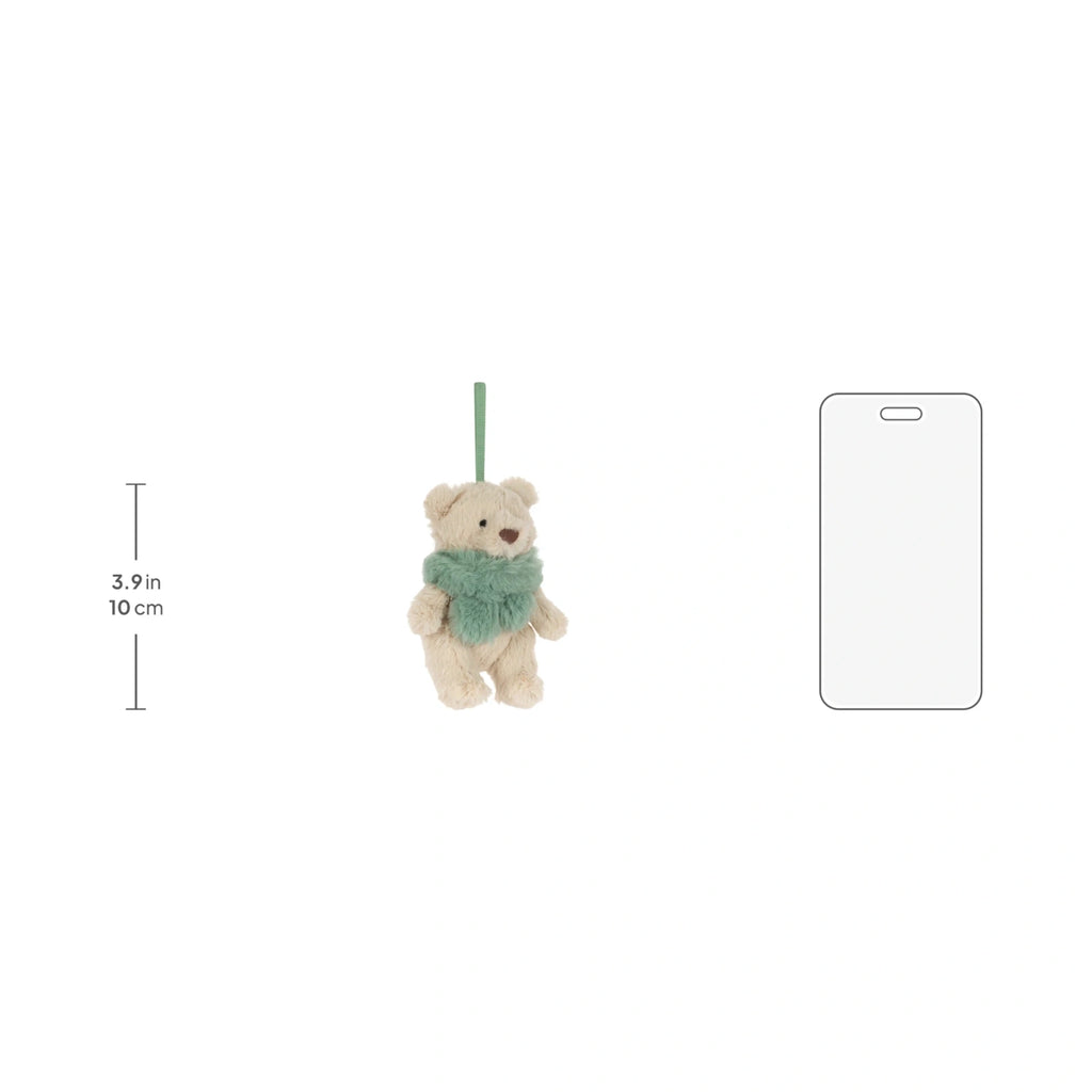 Scale reference of Jellycat Bartholomew Bear Jr Winter Warmer Decoration next to miniature bear with green winter.