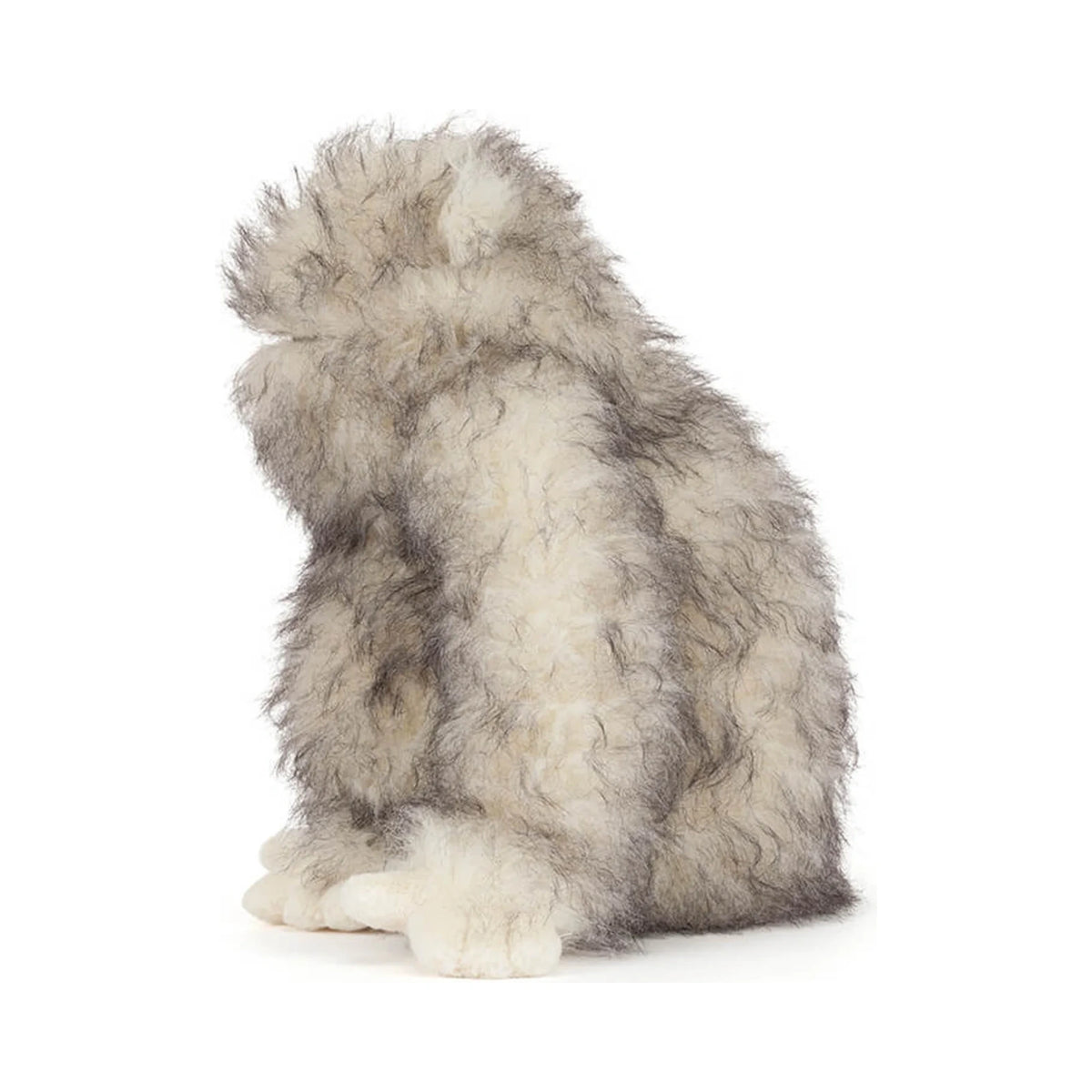 Side view of Jellycat Bretti Yeti showing fluffy cream plush fur with grey tips.