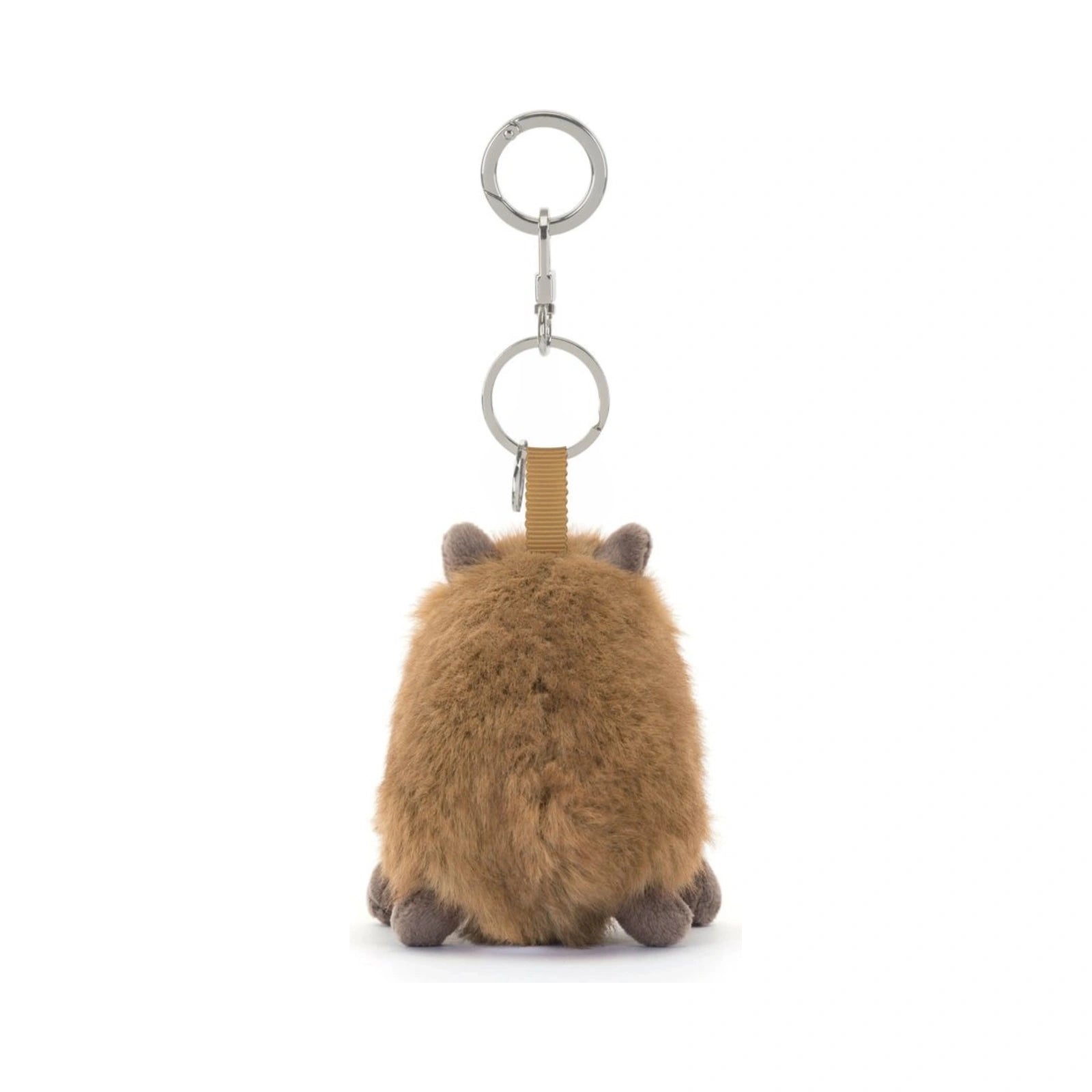 A back view of the Jellycat Clyde Capybara Clip On Charm, featuring fluffy brown plush fur, tiny ears, and small feet, suspended from a silver metal key chain clasp by a tan textured fabric loop.
