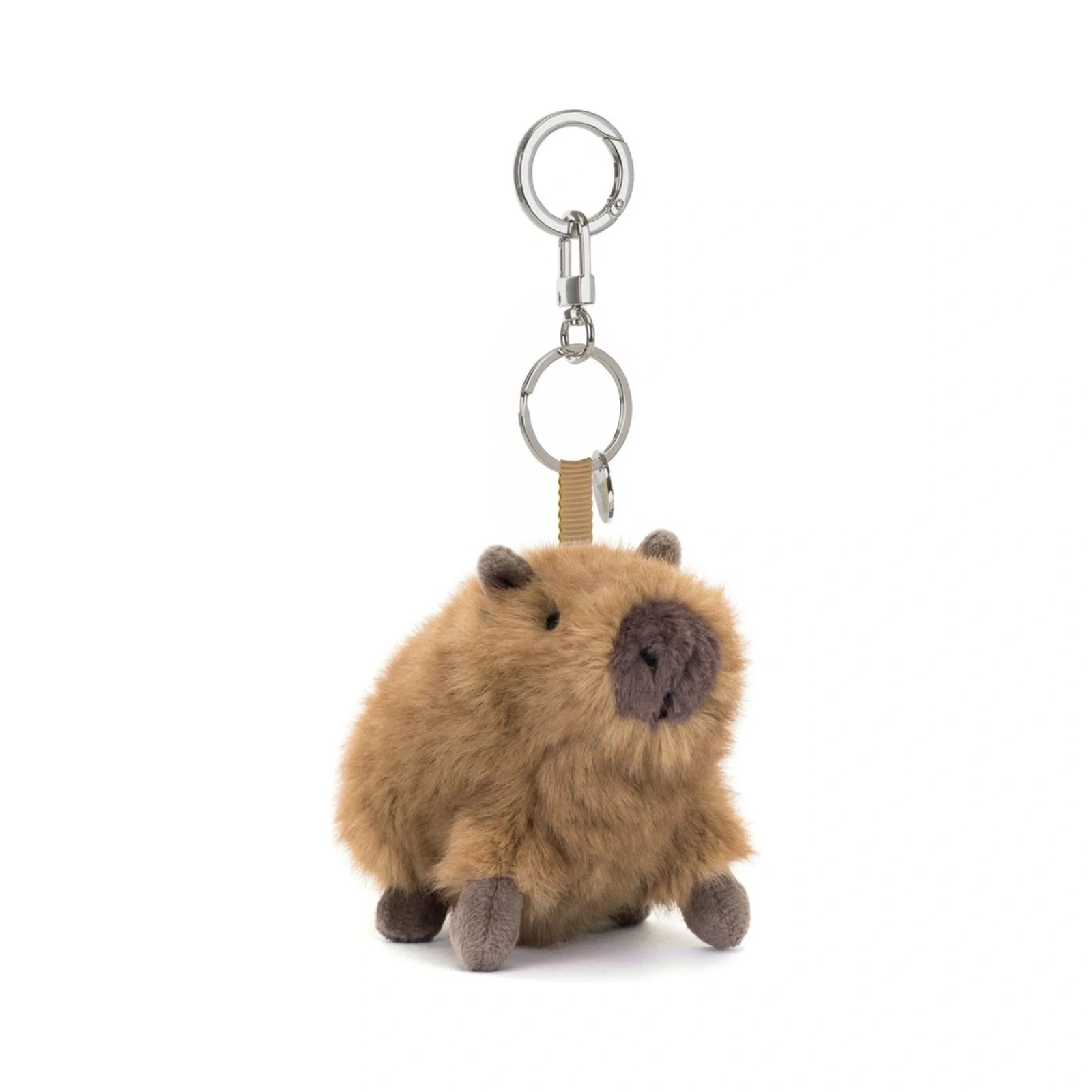 The Clyde Capybara Clip On Charm by Jellycat features a fluffy brown plush capybara with dark brown snout and feet attached to a silver metal clasp.
