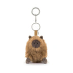 Jellycat Clyde Capybara Clip On Charm features a fluffy brown plush body with a dark grey face and paws attached to a tan fabric strap and silver metal keyring.