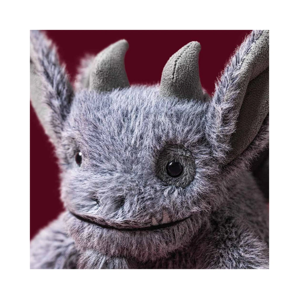 Close-up of detailed soft grey face on Jellycat Growlston Gargoyle.