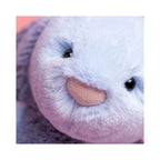 A close up detail of the Jellycat Puddlesea Bunny Original showing its soft light blue plush fur, small black eyes, and a pink textured nose.