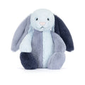 A Jellycat Puddlesea Bunny Original plush toy featuring color blocked patchwork fur in light blue, slate grey, and dark navy blue with a pink nose.