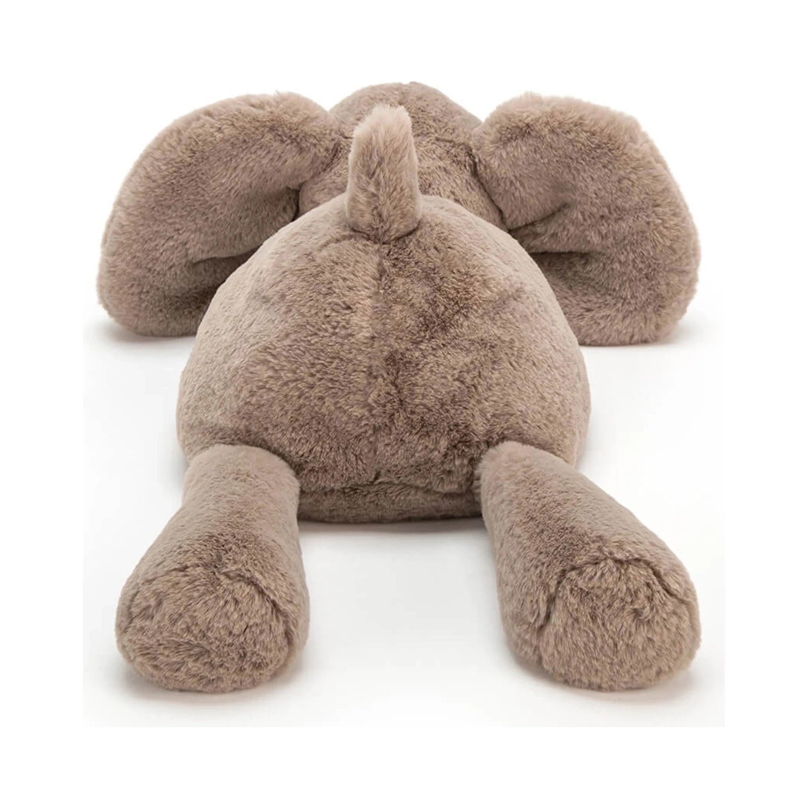 Rear view of the Jellycat Smudge Elephant Medium plush toy in soft taupe brown, showing its tiny fluffy tail, outstretched back legs, and floppy ears against a plain white background.