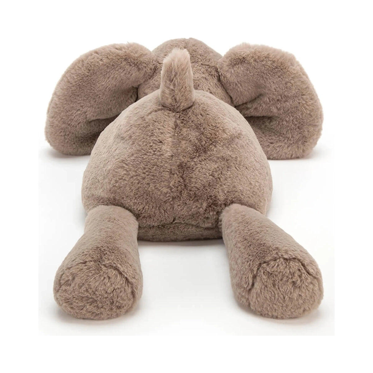 Rear view of the Jellycat Smudge Elephant Medium plush toy in soft taupe brown, showing its tiny fluffy tail, outstretched back legs, and floppy ears against a plain white background.