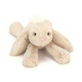 Jellycat Smudge Rabbit Medium stuffed animal in soft beige plush lying down with long floppy ears and a fluffy white tail.