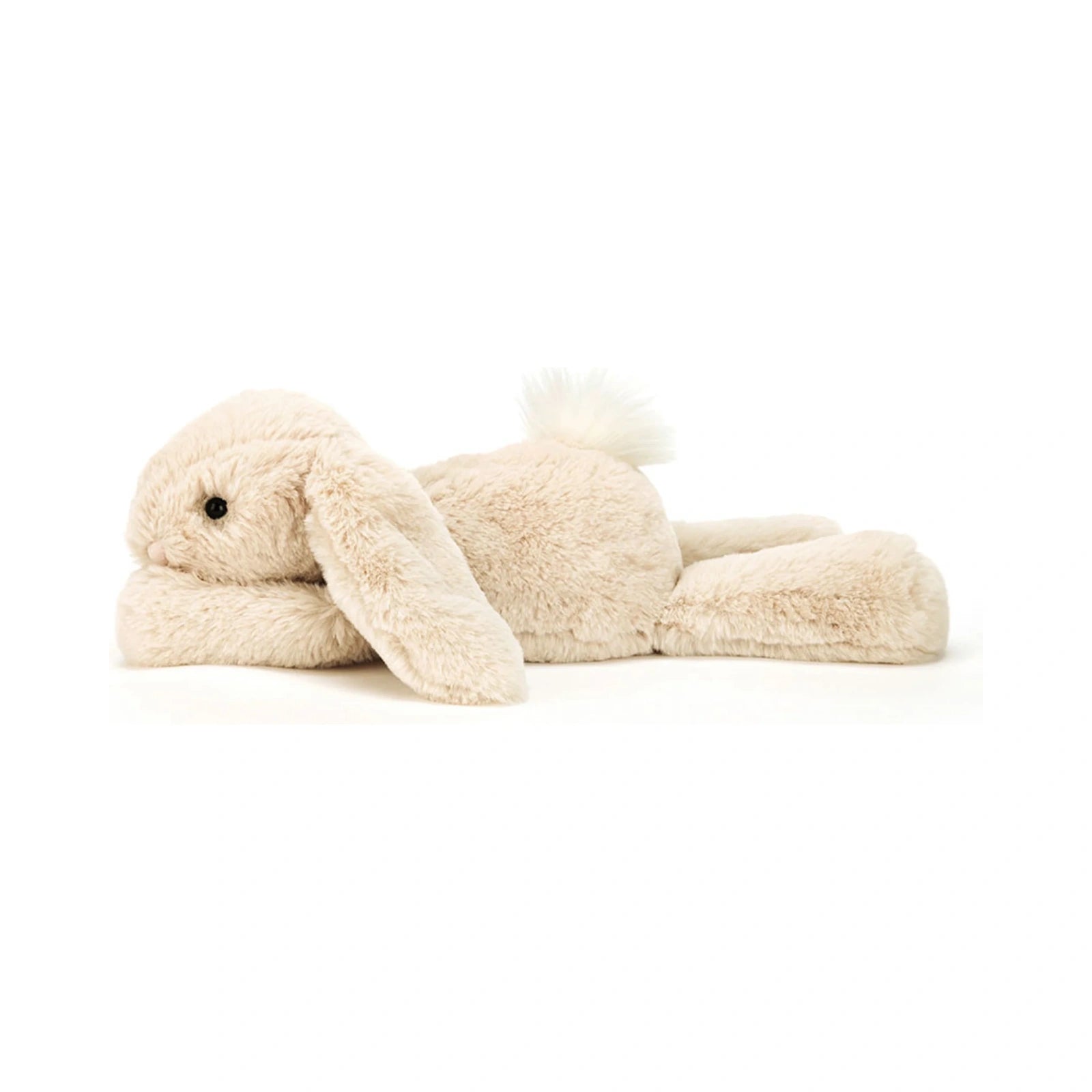 A Jellycat Smudge Rabbit Medium stuffed animal in cream laying flat on its stomach with floppy ears and a fluffy white tail.