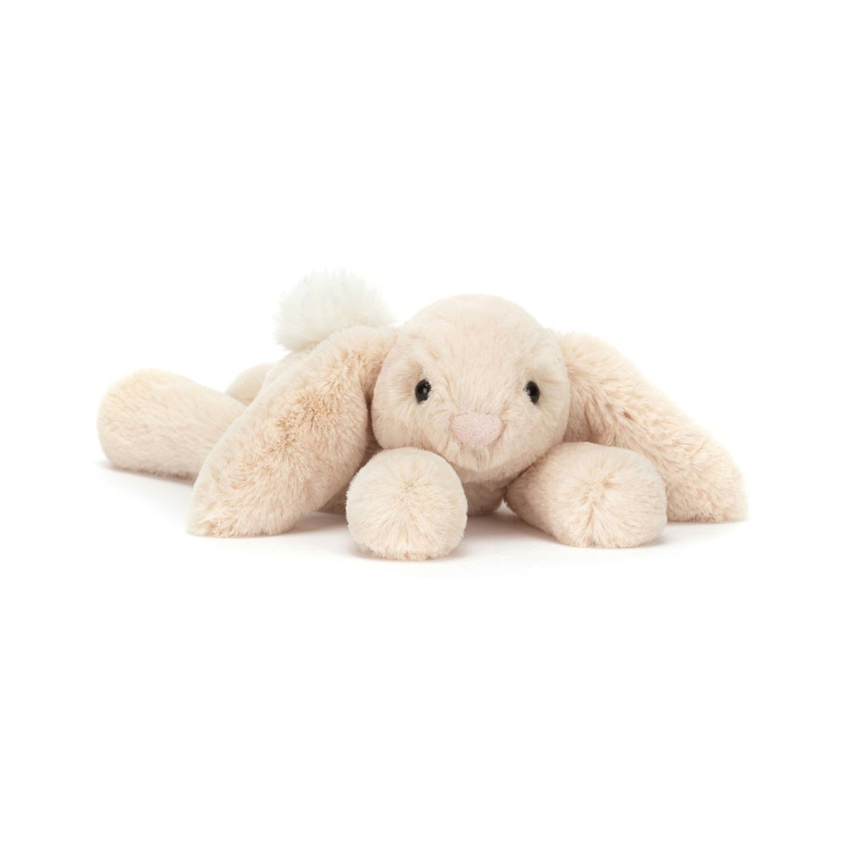 A pocket-sized, incredibly soft plush rabbit with creamy oatmeal-coloured fur, long floppy ears, and a sprawling, relaxed posture.