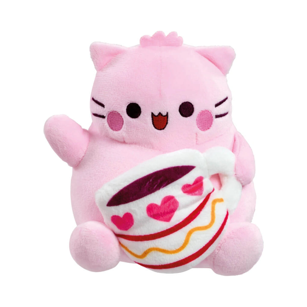 Pembe the Pink Cat coffee small soft toy features a light pink plush cat with black embroidered eyes and whiskers holding a white coffee cup decorated with pink hearts and a wavy orange line.