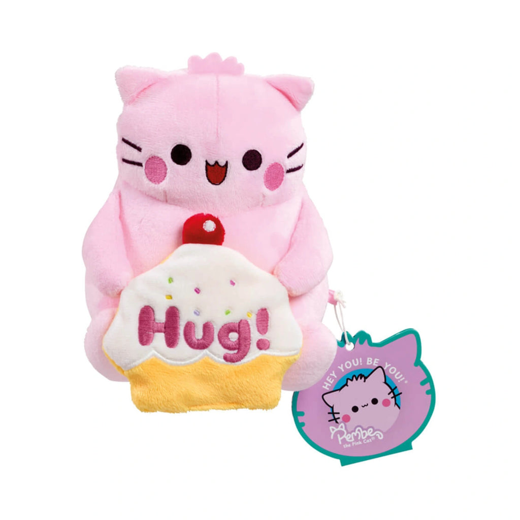 Pembe the Pink Cat plush toy holding a cupcake with embroidered Hug! text and a teal tag on white.