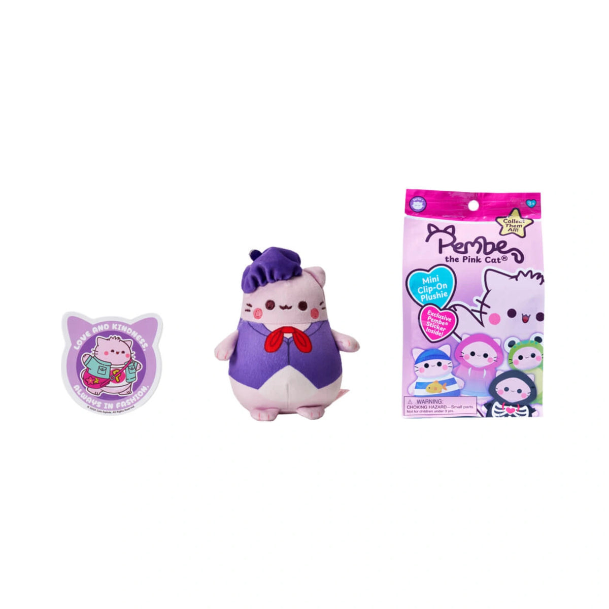 A Pembe the Pink Cat mystery clip on plush featuring a light pink cat dressed in a purple beret, matching purple shirt, and a red bow, displayed next to its sticker and blind bag packaging.