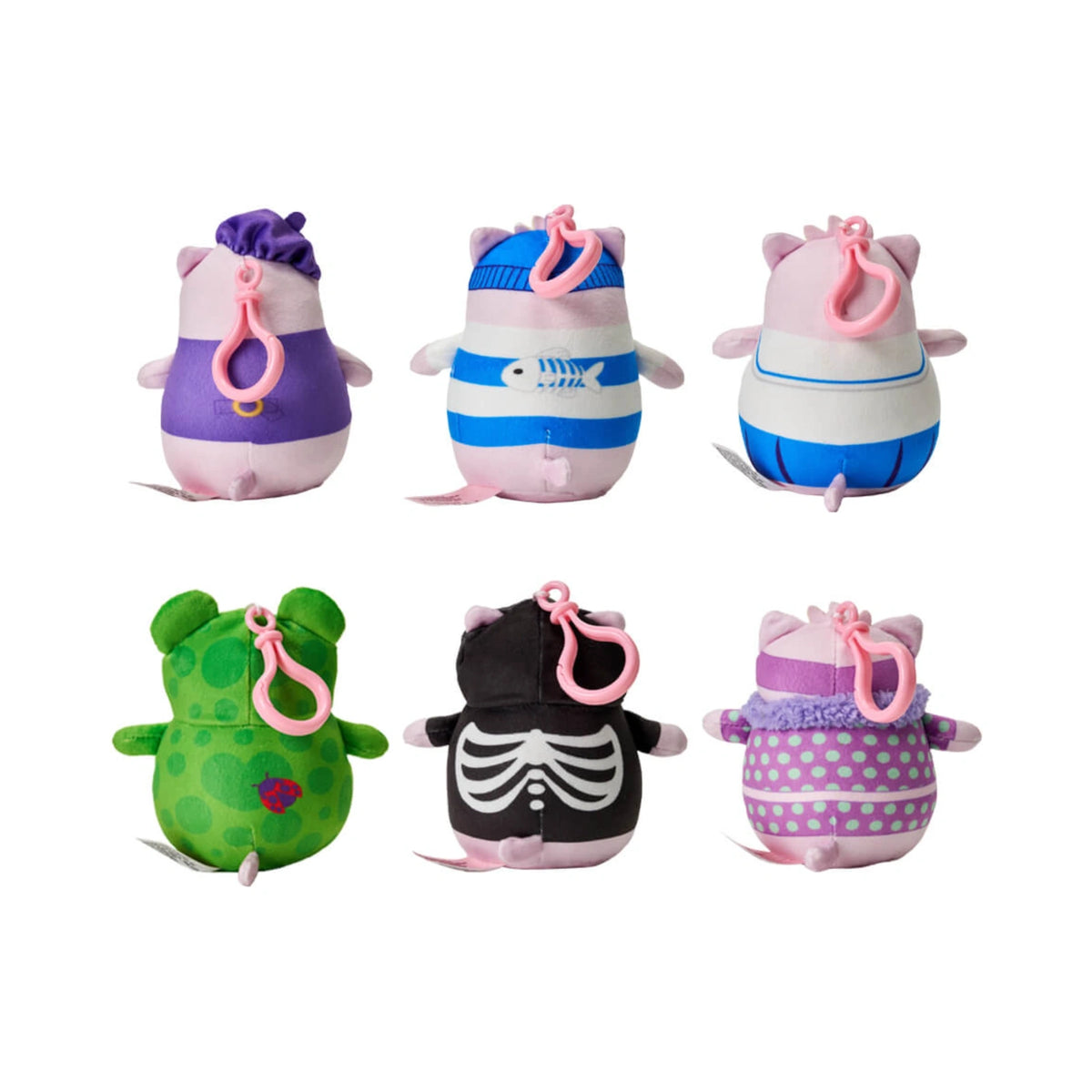 Six Pembe the Pink Cat mystery clip on plush blind bags shown from the back, featuring pink plastic clips and various colorful character outfits like a purple beret, a blue striped sailor suit, a green frog costume with a ladybug print, a black skeleton outfit, and a purple polka dot dress.