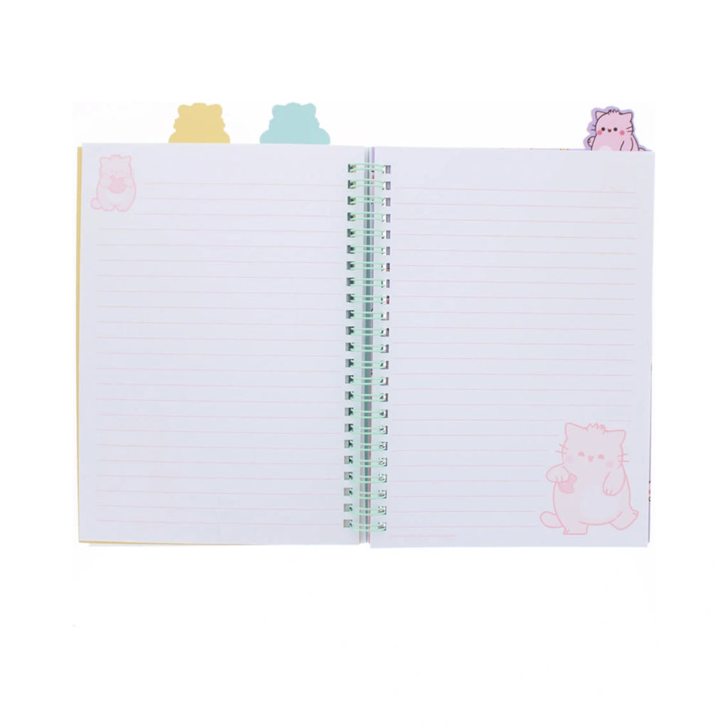 An open PEMBE PROJECT BOOK by Pembe the Pink Cat features pastel pink lined pages decorated with pink cat illustrations, held together by a mint green spiral coil and topped with cute cat shaped index tabs in yellow, blue, and purple.