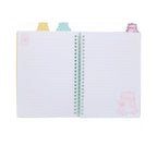 An open PEMBE PROJECT BOOK by Pembe the Pink Cat features pastel pink lined pages decorated with pink cat illustrations, held together by a mint green spiral coil and topped with cute cat shaped index tabs in yellow, blue, and purple.
