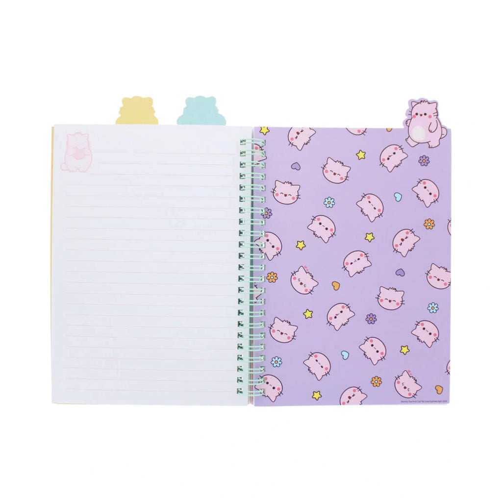 An open Pembe Project Book from Pembe the Pink Cat showing a lined white page on the left and a lavender purple divider page decorated with a pattern of cartoon cat heads, small stars, and flowers with pastel colored cat shaped tabs sticking out from the top.