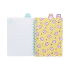 An open Pembe the Pink Cat project book featuring lined pages with light green lines, cute cartoon cat illustrations in the corners, and pastel colored cat shaped divider tabs peeking out from the top.