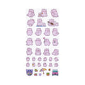 Pembe the Pink Cat puffy sticker sheet showcasing a collection of cute lavender pink cartoon cats in various adorable poses, alongside small illustrations of a rainbow umbrella, a pink bus, and potted cacti.