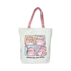Pembe the Pink Cat canvas tote bag in white featuring pink shoulder straps and a four panel graphic of a cute pink cat waving holding a flower and napping above the text Dream Big Nap Often