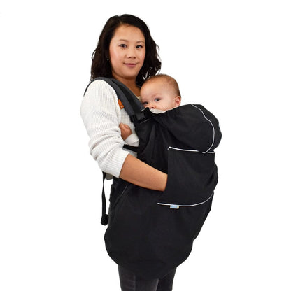 A woman holding a baby in a black baby carrier, providing comfort and support to her little one.